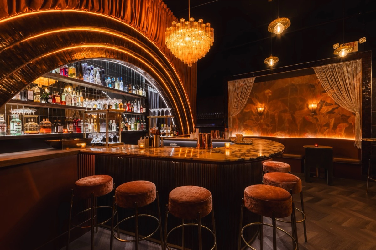 The back-bar arch glowing over the room
